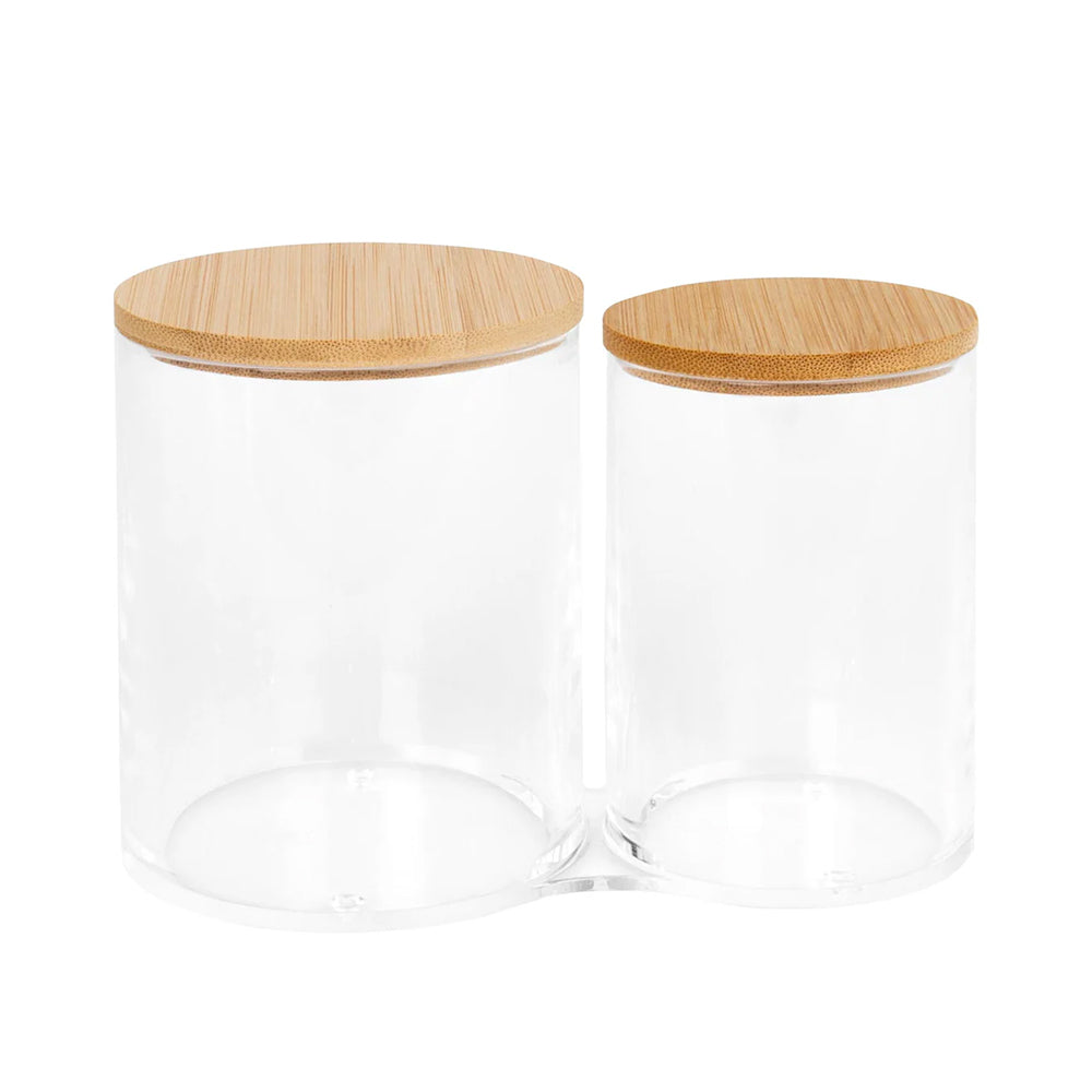 Two glass jars with wooden lids on a white background