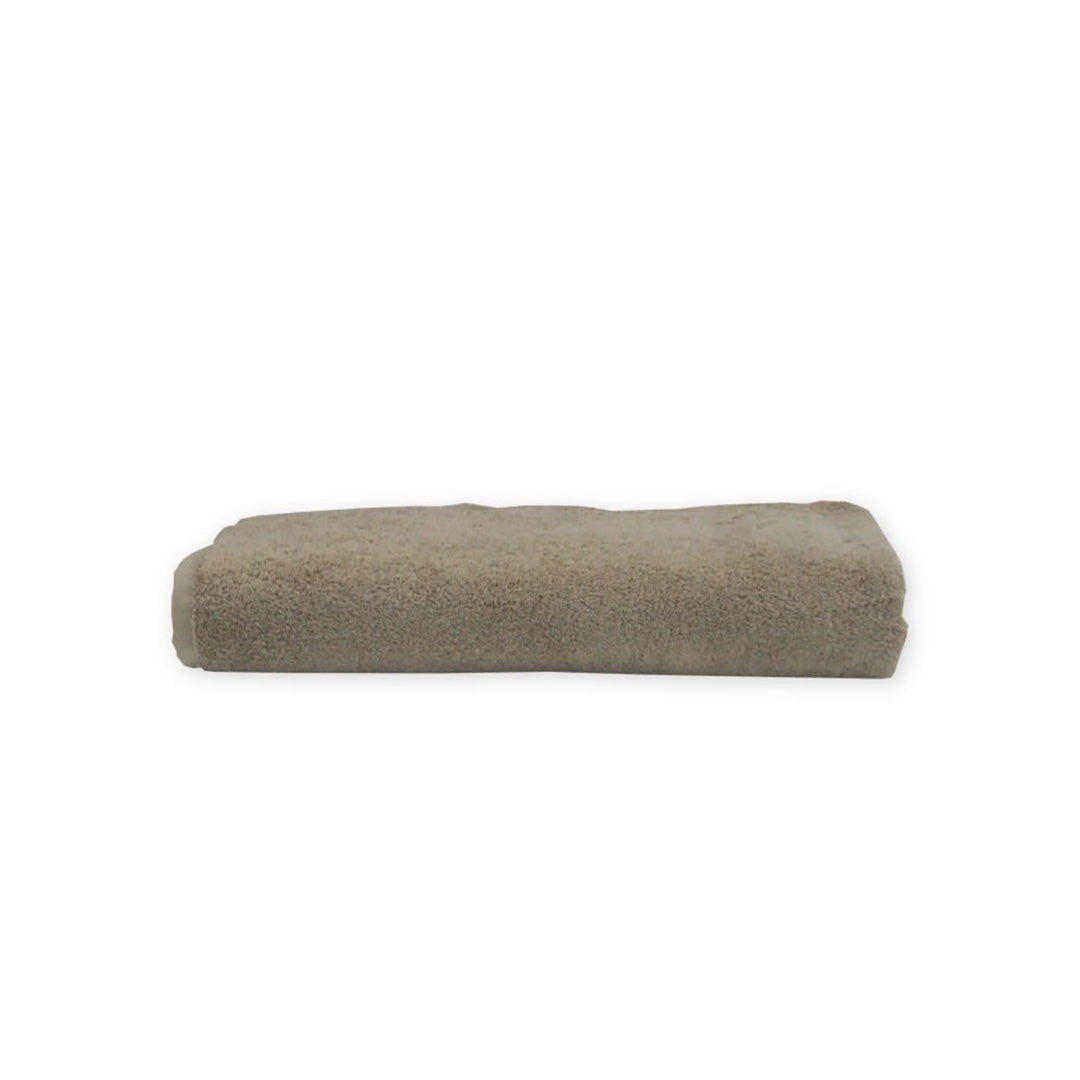 Folded beige towel on a white background
