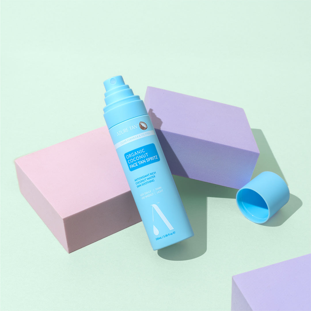 Blue spray bottle with a label on a light green background