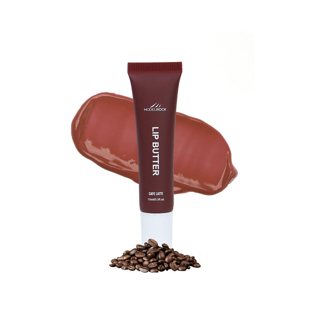 Lip butter tube with a swatch of color and coffee beans on a white background