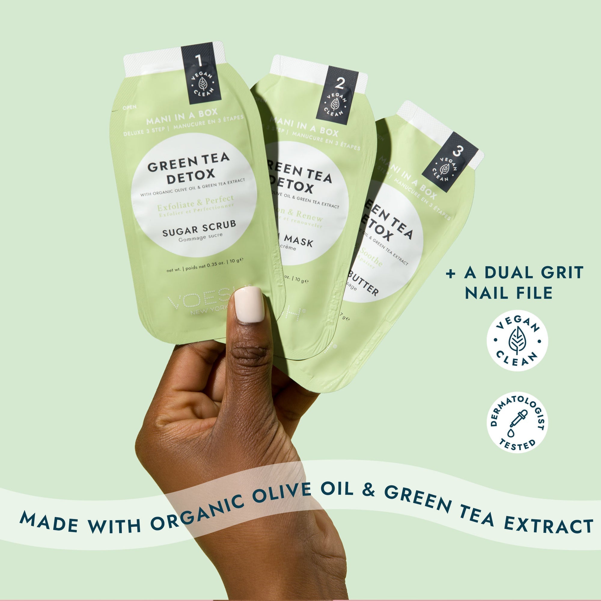 Three green tea detox skincare products held by a hand against a light green background
