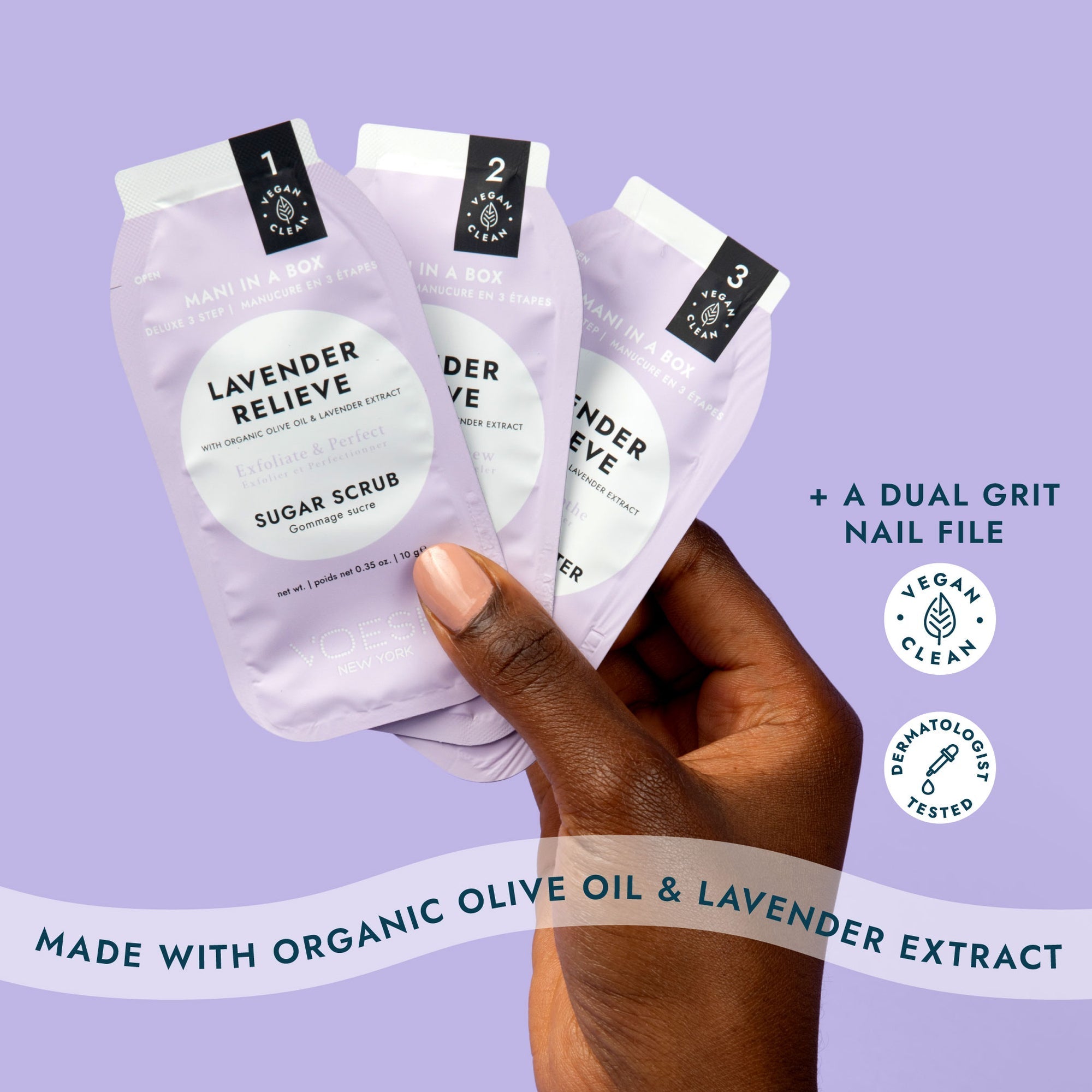 Three packages of Lavender Relieve sugar scrub held by a hand against a purple background.