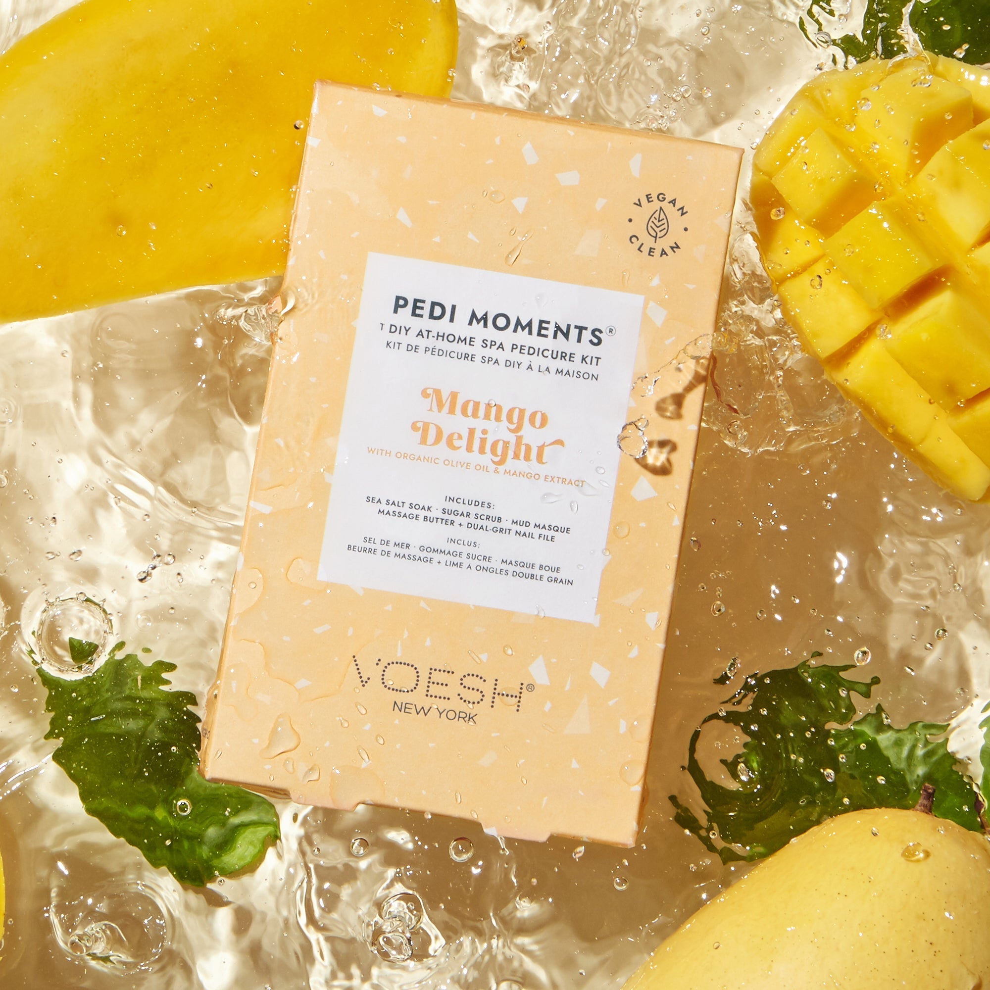 VOESH Pedi Moments Mango Delight pedicure kit with mangoes and mint leaves on a wet surface