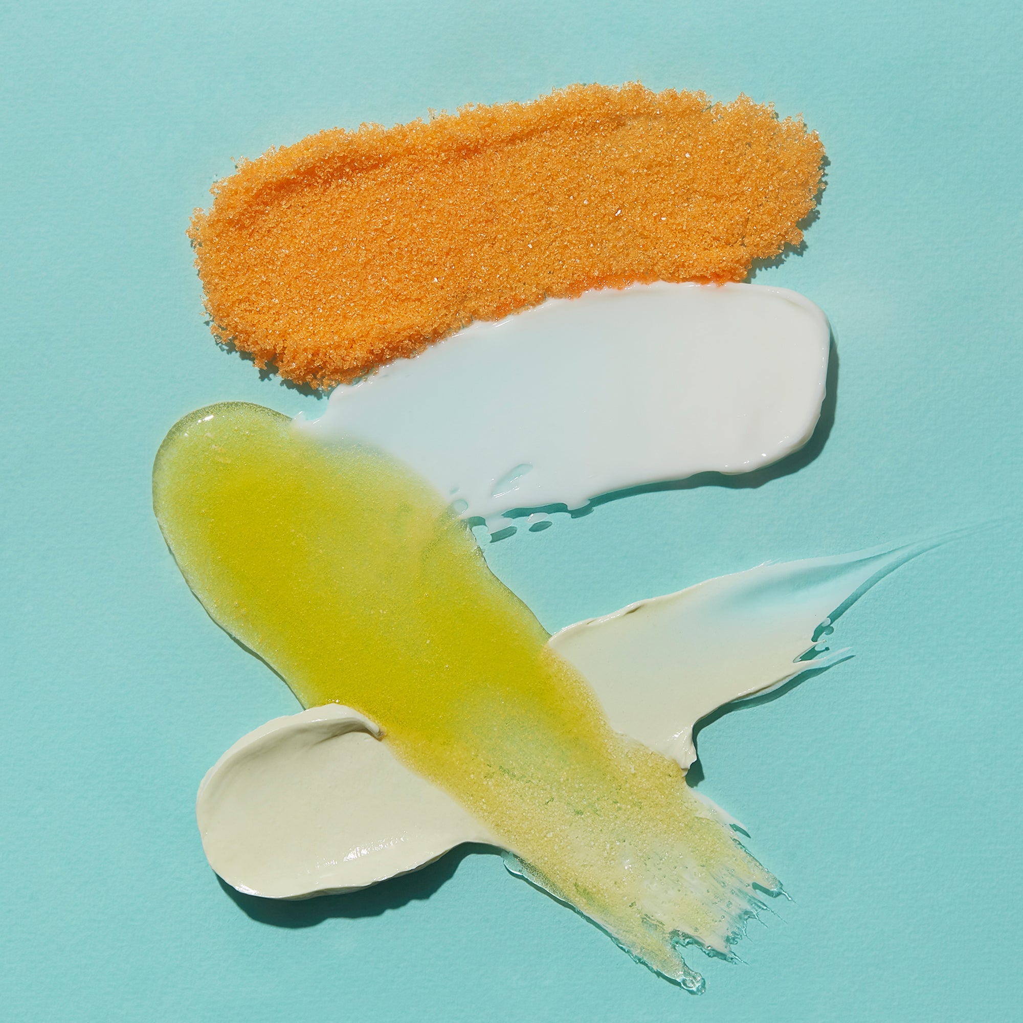 Three colorful paint swatches on a light blue background